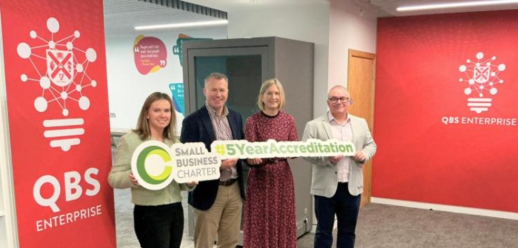 Four people with Small Business Charter logo